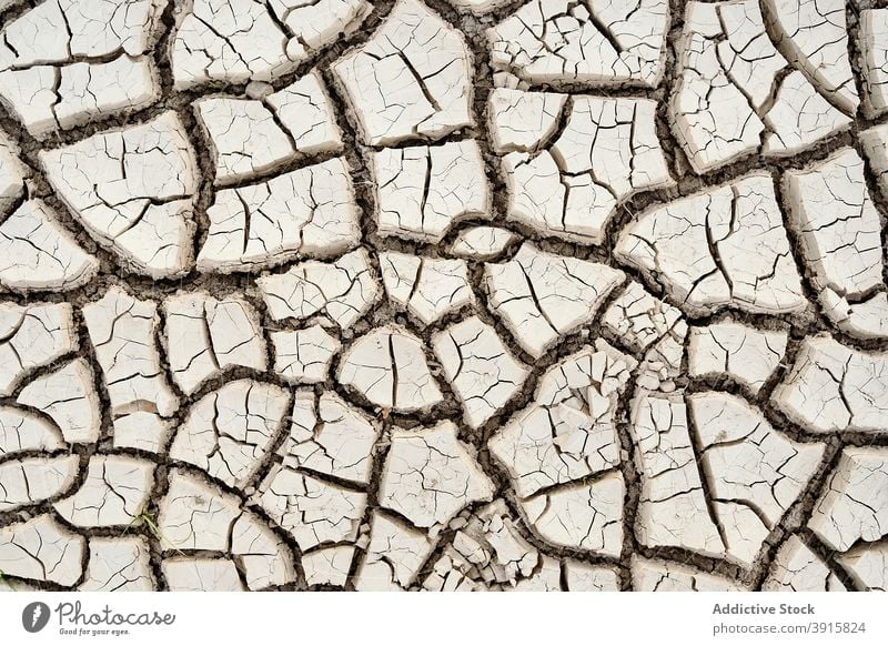 Texture of dried cracked soil drought texture barren waterless background uneven arid dry surface earth nature desert grunge damage terrain environment dirt