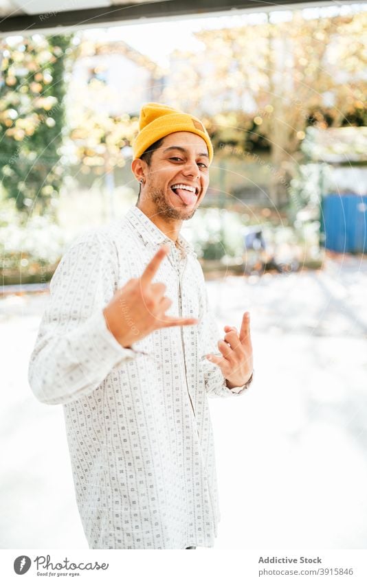 Cheerful hipster man looking at camera cheerful smile informal trendy style hat positive young male beard unshaven happy optimist personality guy charismatic