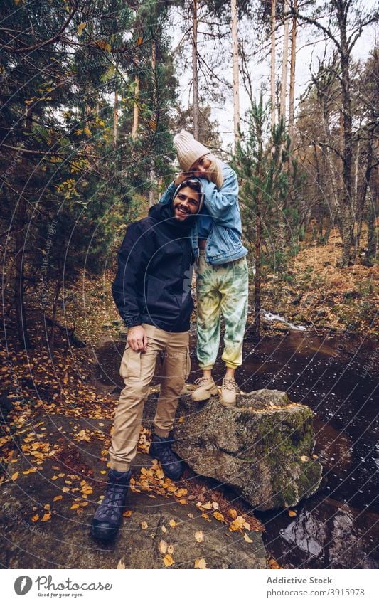 Couple of travelers in autumn woods couple forest admire nature cheerful explore fall together relationship tourism relax happy harmony freedom wanderlust