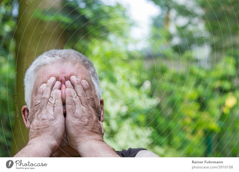 Close up of man holding hands in front of his face Man portrait Emotions Fatigue Fear Anonymous tired exhausted Exhaustion Human being Adults Sadness