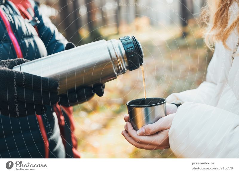 Women having break drinking hot tea during autumn trip on autumn cold day active activity adventure backpacker coffee cup destination enjoy exploration explore