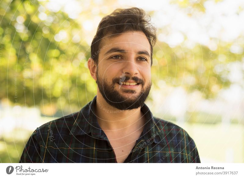 Bearded man in outdoors park. Smiling disheveled men male 40s adult attractive autumn beard bearded cool happy handsome lifestyles smile portrait head shot