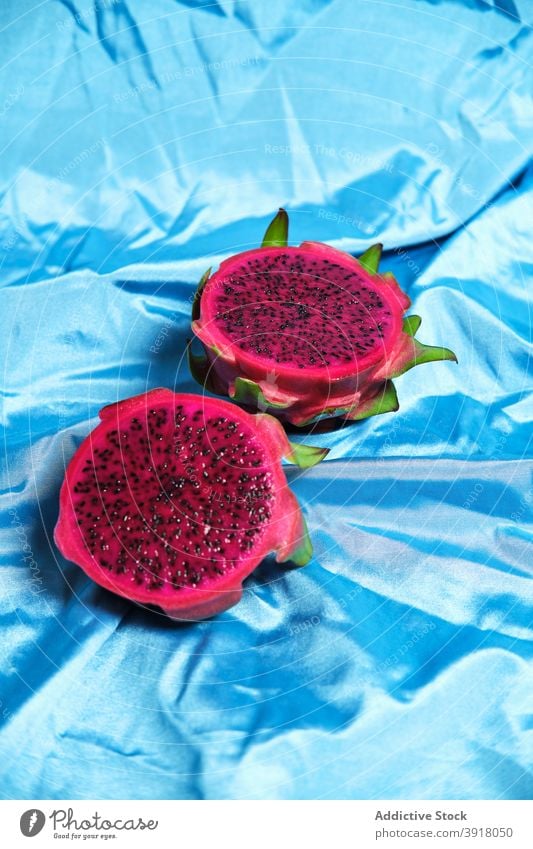 Tropical dragon fruit on blue background in studio pitaya half delicious exotic slice tropical sweet bright tasty food fresh healthy vibrant healthy food raw