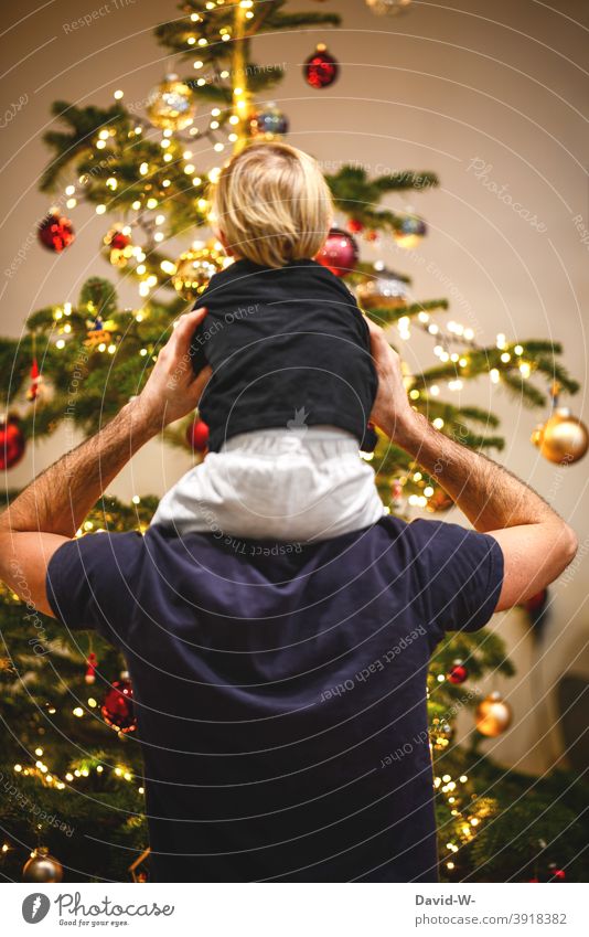 Father and child in front of the decorated Christmas tree Christmas & Advent Child Family christmas eve Together Parents Joy in common fortunate