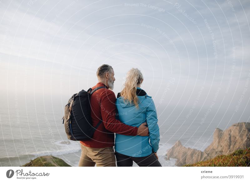 senior couple looking at the sea together on vacation woman people family love happy travel nature sky outdoors hiking mountain tourist walking holiday water