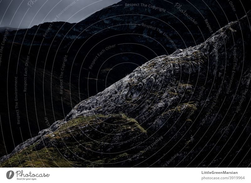 Illuminated mountain side Mountain Light Shadow Contrast high contrast darkness Rock Moss Grass Clouds Stone Rubble Steep Hiking Alpine Landscape Exterior shot