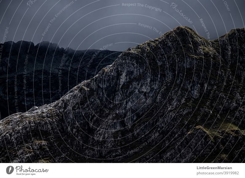 Illuminated mountain side Mountain Light Shadow Contrast high contrast darkness Rock Moss Grass Clouds Stone Rubble Steep Hiking Alpine Landscape Exterior shot