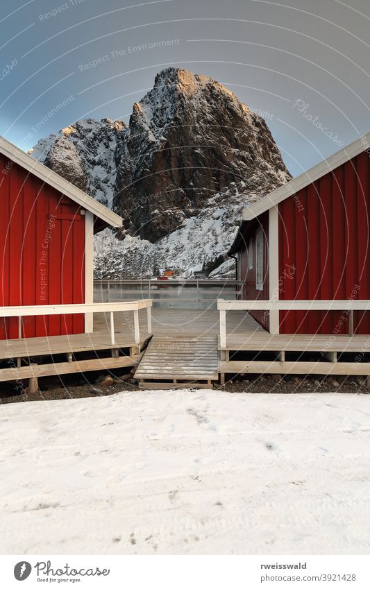 Tourist rorbuer-traditional fishing cottages-Festhaeltinden mount across the fjord. Hamnoy-Reine-Moskenesoya-Lofoten-Norway. 0225 fishing port village hamlet