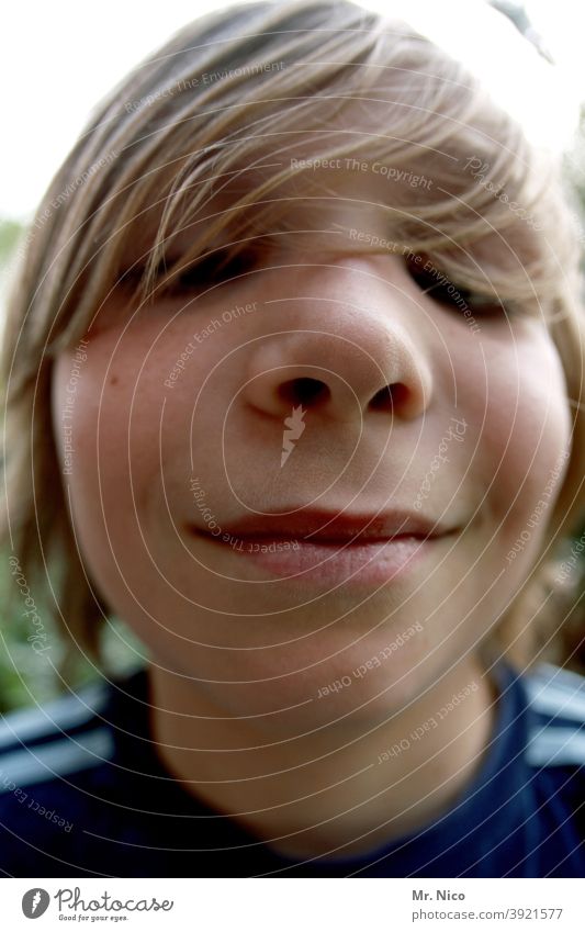 Boy looking curiously into the camera Brash Cheeky in the camera grin Boy (child) Looking into the camera portrait Face Head Hair and hairstyles Fisheye