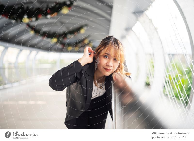 Beautiful woman at handrail. Thai Asian female working woman outfit cool smart semi-formal casual after work free time outdoors travel unique beautiful relaxed