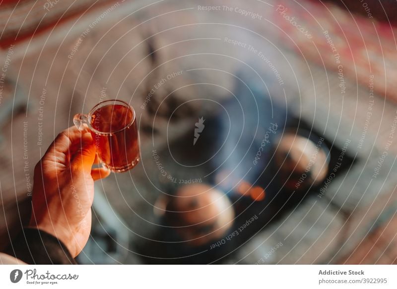 Crop traveler with cup of hot tea man enjoy drink hot drink beverage vacation male wadi rum jordan aromatic rest holiday tourism mug relax glass teatime guy