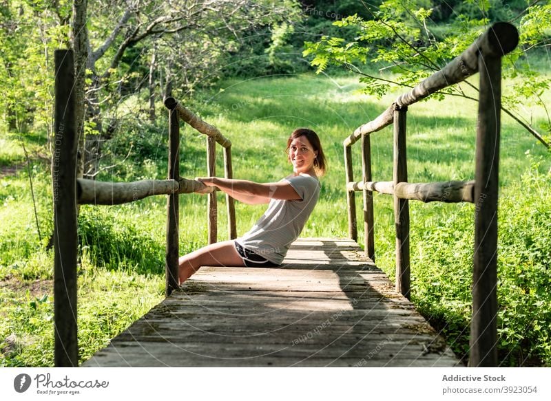 Woman relaxing on bridge in forest woman woods summer river enjoy carefree nature female peaceful tree sit freedom water creek brook old tranquil calm