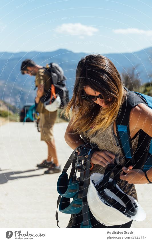 Climbers preparing for rappelling in mountains climber mountaineer prepare active equipment helmet friend practice safety woman training activity nature