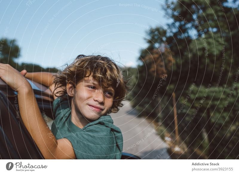 Kid looking out of car window in nature kid mountain adventure summer boy travel trip enjoy male preteen automobile child journey vacation holiday vehicle