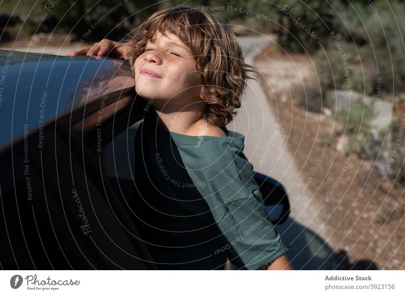 Kid looking out of car window in nature kid mountain adventure summer boy travel trip enjoy male preteen automobile child journey vacation holiday vehicle