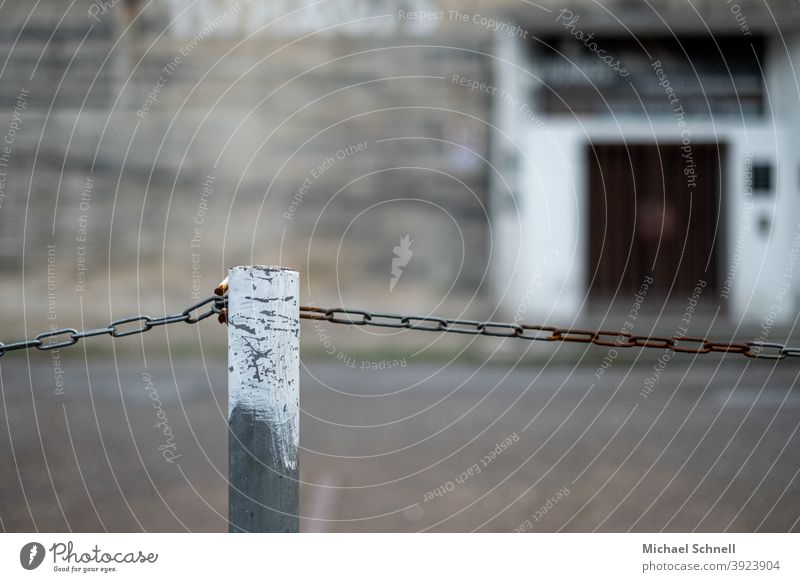 Chain and bar as demarcation of a parking lot cordon Old Rust Metal Colour photo Exterior shot Deserted Chain link Safety Shallow depth of field Iron demarcate