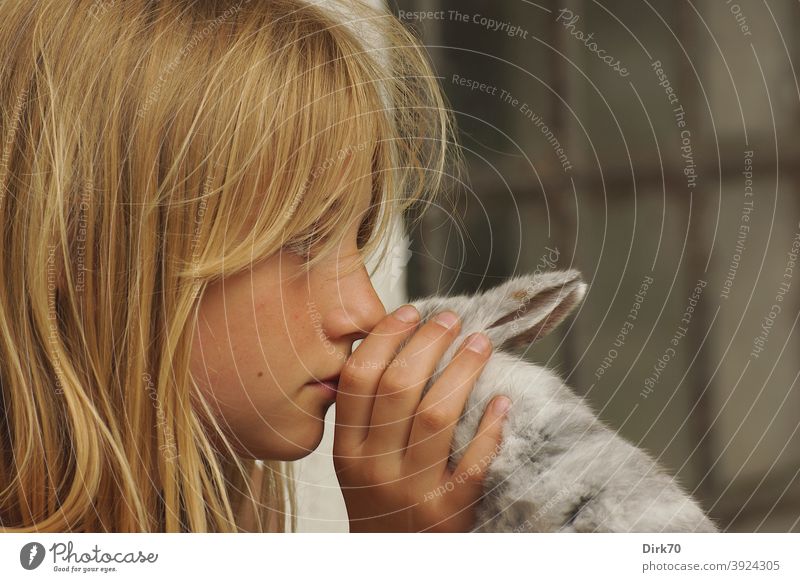 Portrait of a young girl with rabbit in profile Girl Girlish Girl`s face Profile Meditative reflectiveness tranquillity quiet scene tender tenderness