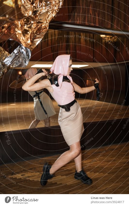 A fashion shoot for a latex clothing brand with a beautiful model dressed in pink. The retro vintage wooden background is a beautiful match for this one.