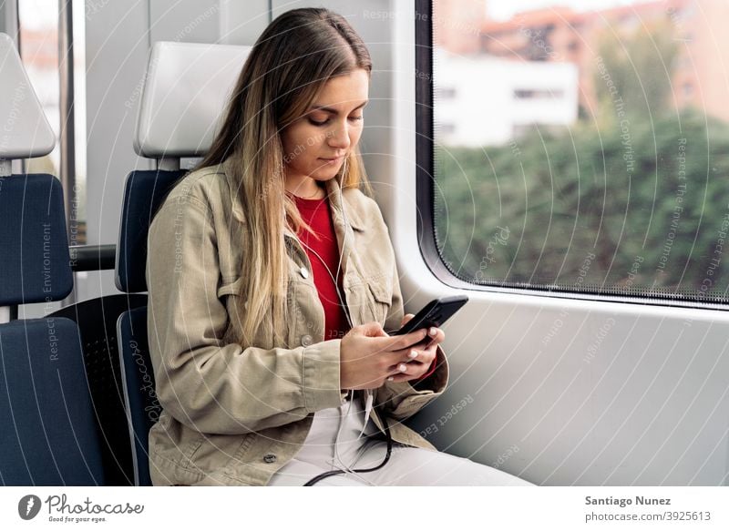 Blonde Girl in Train train traveling headphones girl portrait young 20s front view blonde pretty using phone cellphone caucasian looking standing woman female