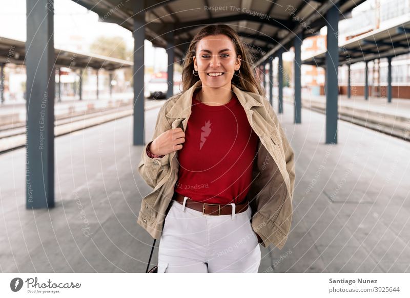 Happy Woman Portrait walking portrait looking at camera platform standing pretty woman girl young female outside outdoors front view posing one person alone