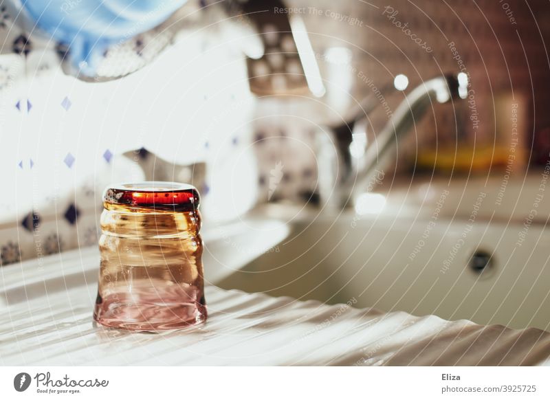 A water glass is left to dry next to the sink after washing up. Glass dish washing neat Dry Sink Tumbler Sun Crockery Kitchen Household Rinse rinsed