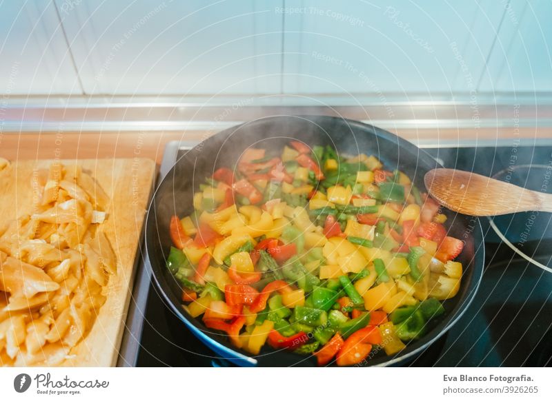 unrecognizable woman preparing vegetables food in pan. Healthy food kitchen pepper colorful healthy stir low carrot cabbage cut spoon vegan red sauteed broccoli