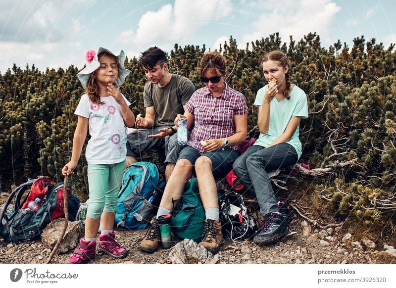 Family having break and eating snacks during trip in mountains. Family actively spending summer vacation together activity adventure female freedom fun green