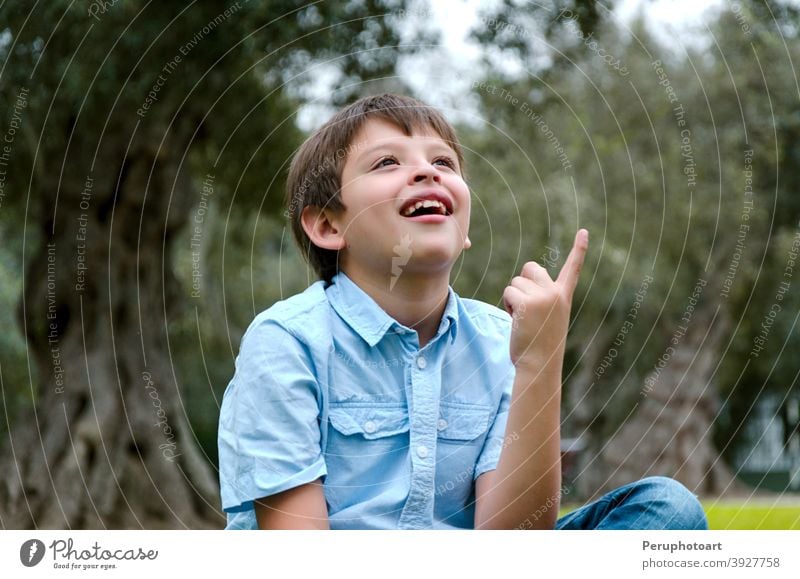 Portrait child with blond hair has an idea, pointing with finger up man happy male person boy young one people face guy hand handsome expression creativity