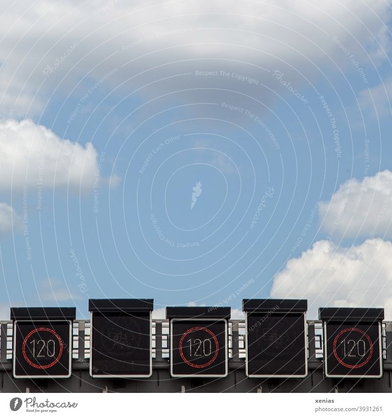 Three times speed indicator 120 km/h on a highway leads directly into the blue sky above with fluffy clouds speed display Transport Highway Road traffic Sky