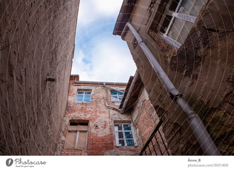 Backyard - houses in need of renovation Courtyard Manmade structures Sky Skyward Architecture Wall (barrier) Building stone Wall (building) Facade Window