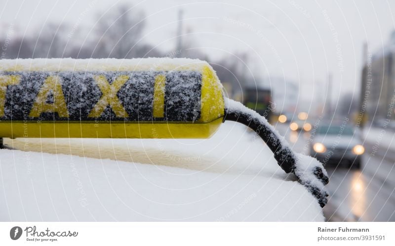 A taxi stands on the side of the road in a city. It is a gloomy winter day, there is some snow. Town Snow Transport Taxi Winter Exterior shot Means of transport