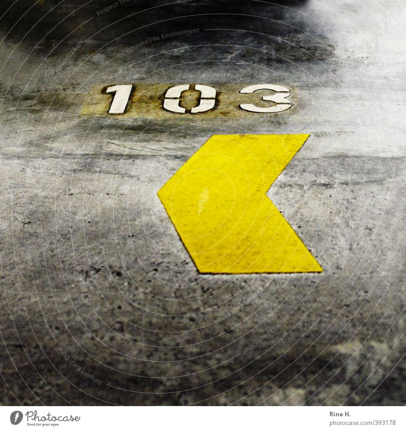 <103 Parking garage Arrow Authentic Yellow Concrete Digits and numbers Square Signs and labeling Parking space number Colour photo Interior shot Deserted