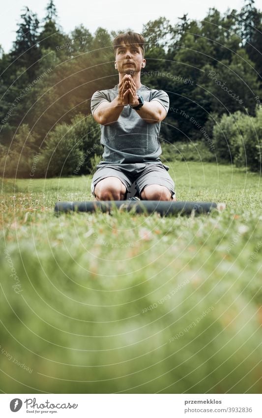 Young man doing exercises outside on grass during his calisthenics workout active activity athlete athletic body bodybuilder bodybuilding care caucasian cross