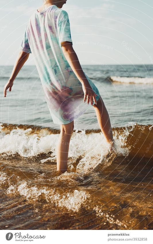 Girl spending a free time enjoying the sea and a beach during summer vacation excited positive sunset emotion carefree nature outdoors travel happiness happy