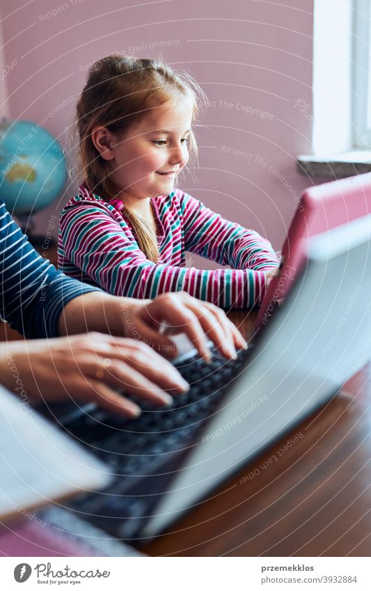 Little girl preschooler watching video on tablet while woman mother working doing her job remotely bed bedroom binder call chat child class classes computer