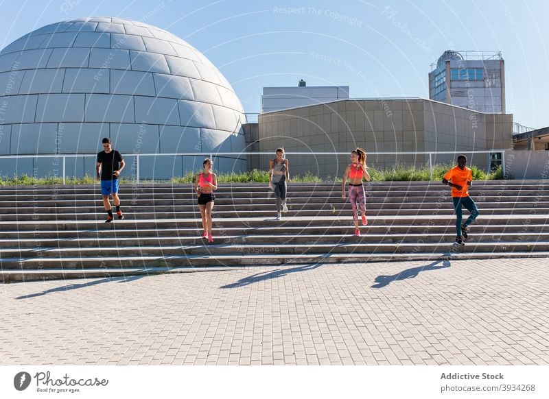 Sportspeople running in city during training runner sportspeople group together team unity cardio multiethnic multiracial diverse black african american workout