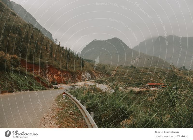 Cinematic foggy winding road to the karst mountains in Meo vac District, Ha giang Vietnam unesco holiday destination empty road north vietnam tourism landscape