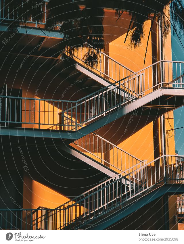 Colorful staircase with yellow wall on sunny day. Wallpaper of a building with copy space. Architecture Stairs Light City Street Copy Space Steps Yellow