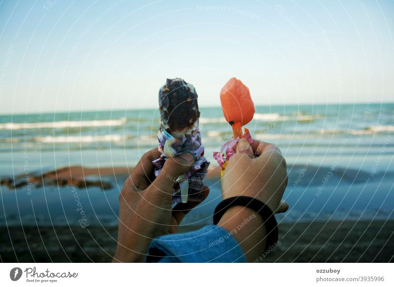 couple holding ice cream at beach Beach Day person summer fun adult hand friendship female woman dessert food sweet horizontal milky multiracial offspring pop