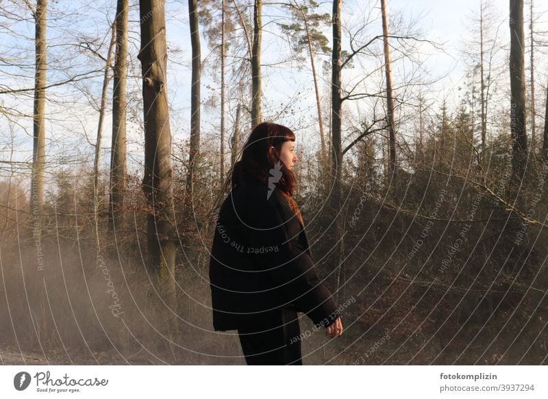 Young woman in front of bare trees Woman young adults Youth (Young adults) Girl Long-haired look Looking feminine Identity 18 - 30 years spring youthful