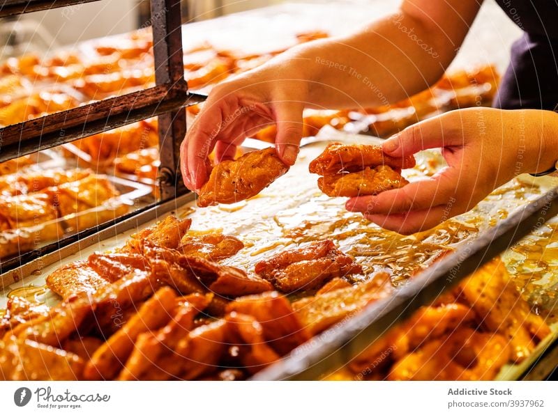 Baker taking sweet pastry from tray bakery food fresh production patisserie yummy appetizing dessert caramel tasty delicious culinary cook snack tradition treat