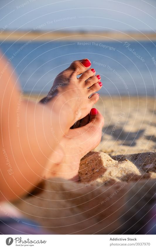 Crop woman relaxing on beach in summer vacation lying sand tourist idyllic sunny female fuseta beach algarve portugal tourism rest trip journey travel coast