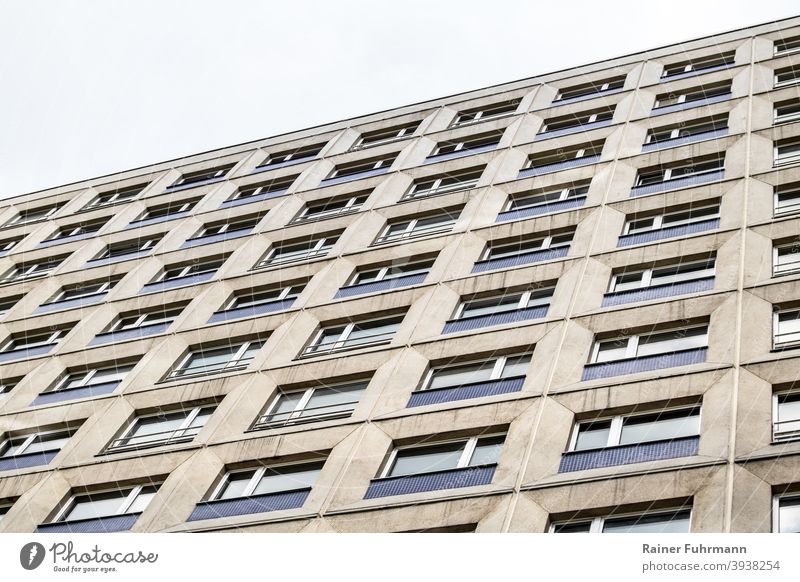 a grey facade of a skyscraper rises into the sky Facade House (Residential Structure) High-rise Apartment Building Gray Anonymous Window Architecture Town