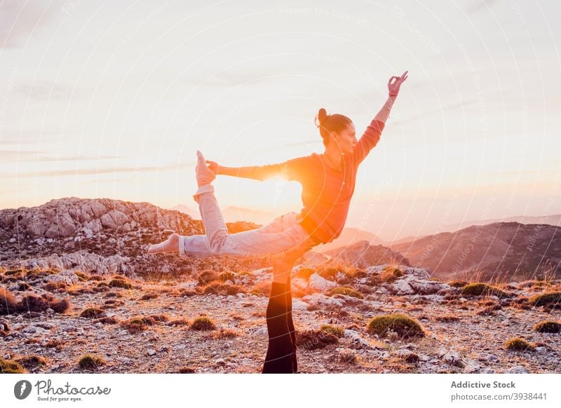 Crop anonymous person supporting concentrated woman performing Natarajasana yoga pose in mountains natarajasana lord of the dance together balance wellness