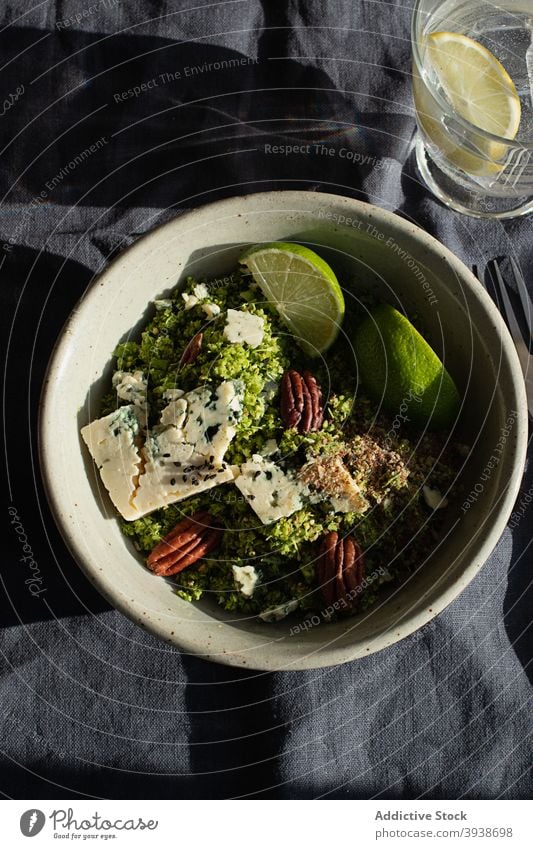 Broccoli salad with couscous on table roquefort cheese lime walnuts homemade diet vegetable lunch tasty plant health natural ingredient nutrition vegetarian