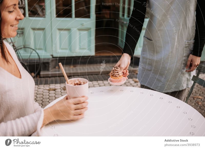 Woman enjoying dessert in cafe confectionery cupcake candy eat coffee woman sweet food cafeteria female serve tasty delicious yummy treat customer client drink