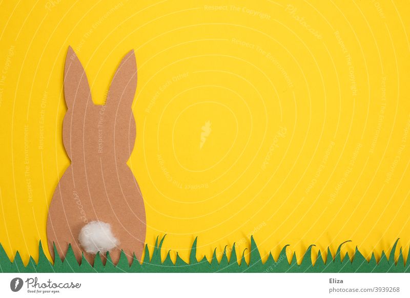 Easter crafts - Easter bunny sits in the grass on a yellow background Easter Bunny handicraft Handicraft rabbit Paper Grass Spring Yellow Easter decoration