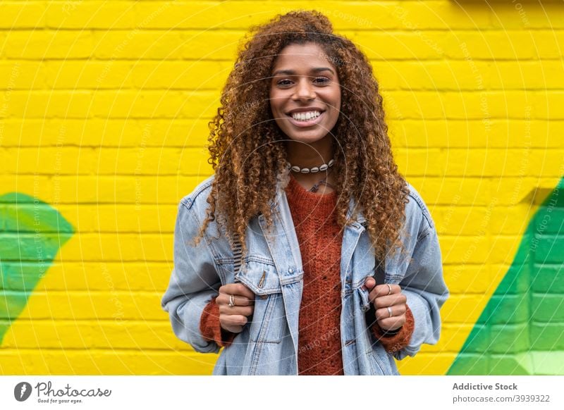 Cheerful young African American lady smiling at camera woman smile optimist style delight street positive satisfied cheerful excited appearance female