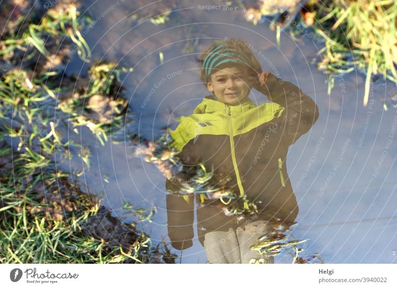 surreal II - portrait of a boy in black and yellow jacket and grey trousers reflected in a puddle on a country lane Human being Child Boy (child) Puddle