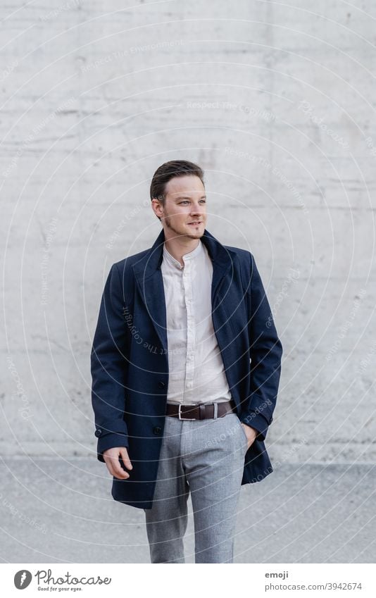 young man, business, outside in front of concrete wall masculine more adult Upper body Young man Man Friendliness Smiling Business Businessman Happiness